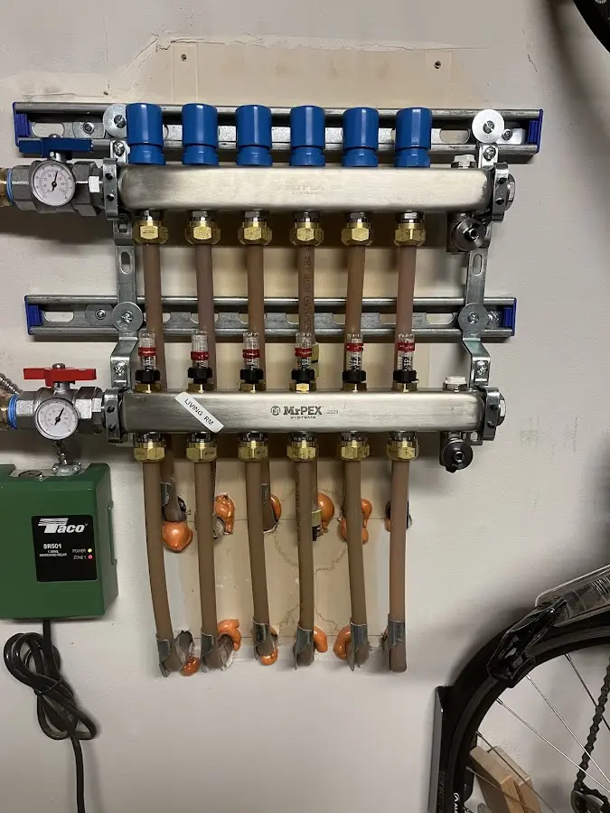 Plumber performing Water Heater Repair at a residential property in Raymond